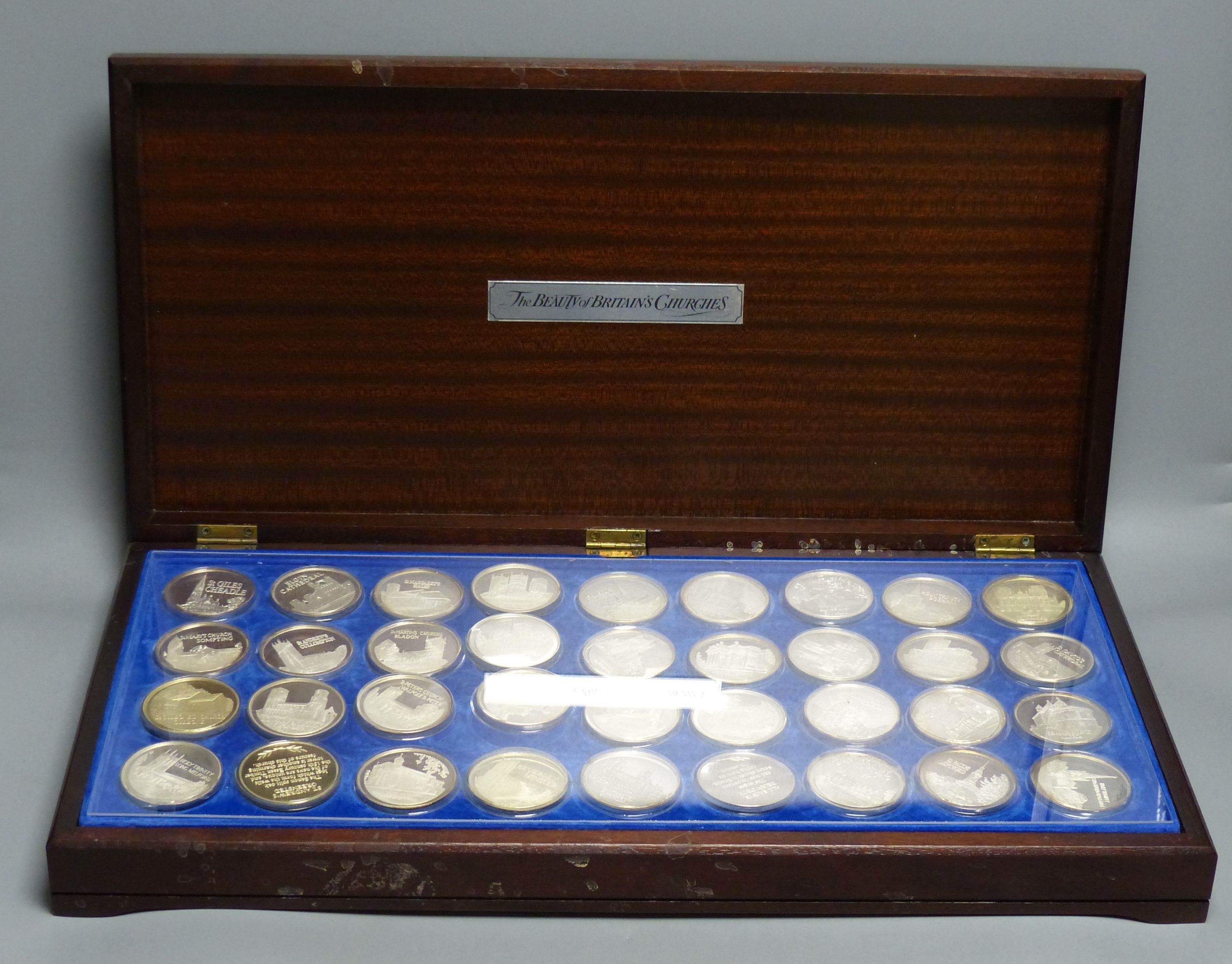 A cased set of 36 silver 'The Beauty of British Churches' medallions,